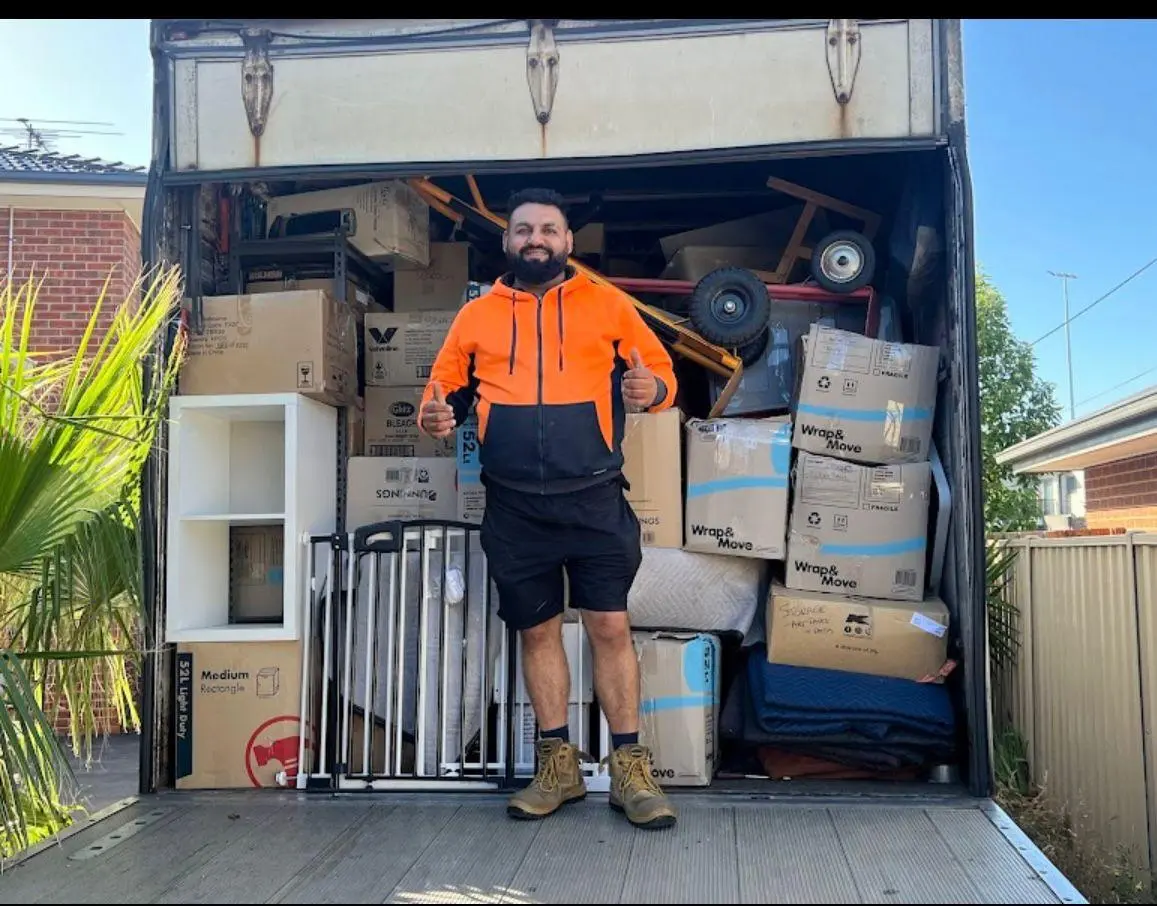 Big Stuff Movers crew member standing in a fully loaded moving truck after a completed move